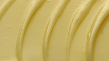 Crane macro texture of yellow face cream with mango butter