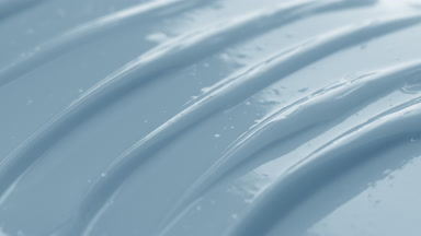 Macro shot of blue skincare cream with moving light source