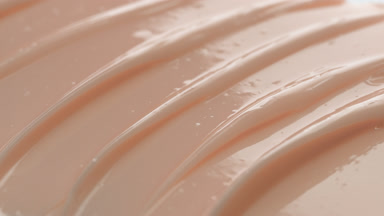 Macro shot of beige skincare cream with moving light source