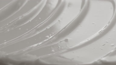 Macro shot of white retinol night cream with moving light source