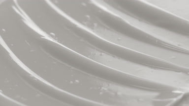 Macro shot of white nourishing cream with moving light source