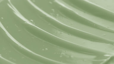 Macro of green tea nourishing cream with moving light source