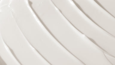 Side view macro turntable shot of white face care cream