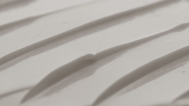 Macro crane shot of white night cream texture in the shadow