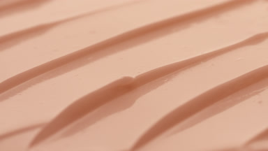 Macro crane shot of beige night cream texture in the shadow