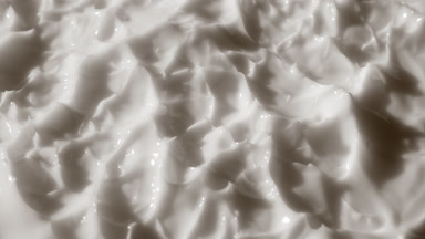 Side view macro shot of white lifting cream surface
