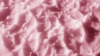 Side view macro shot of pink lifting cream with rose oil surface
