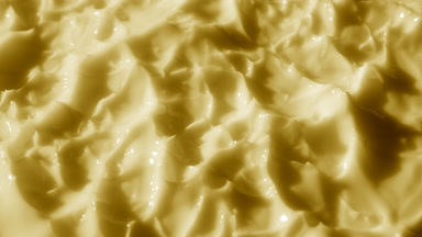 Side view macro shot of yellow lifting cream with collagen surface