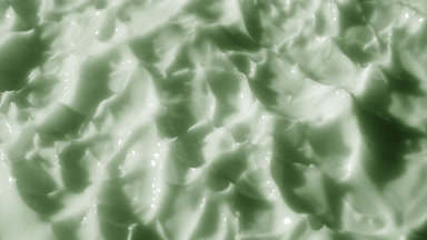 Side view macro of green lifting cream with hemp oil surface