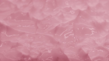 Macro of pink cosmetic cream with rose oil surface in the shadow