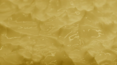 Yellow cosmetic cream with calendula oil surface in the shadow