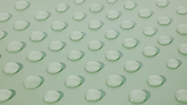 Macro crane shot of moving clear drops on green background