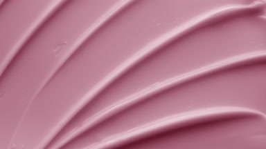 Crane macro shot of pink anti-aging cream with vitamins C and E