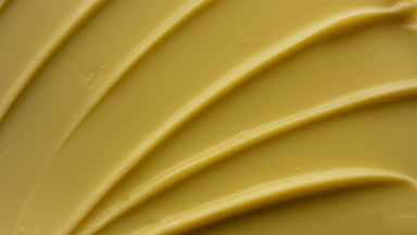Crane macro shot of yellow anti-aging cream with coenzyme Q10