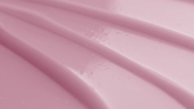 Macro shot of pink cream texture with reflection of light on it