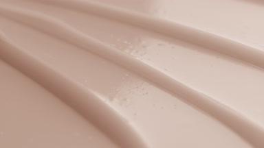 Macro shot of beige cream texture with reflection of light on it