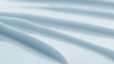 Macro of blue cream texture with a reflection of light on it