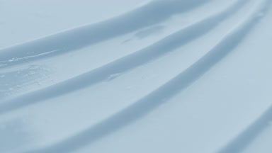 Blue nourishing cream furrow texture with a reflection of light