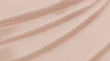 Beige nourishing cream furrow texture with a reflection of light