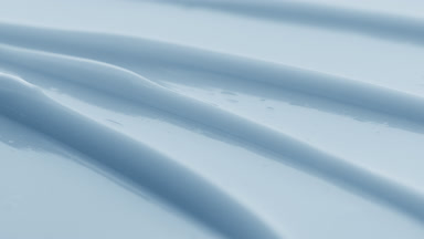 Blue eye care cream furrow texture with a reflection of light