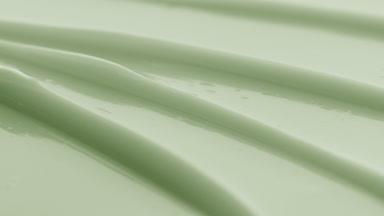 Green eye care cream furrow texture with a reflection of light
