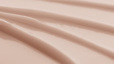 Beige eye care cream furrow texture with a reflection of light