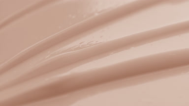 Beige face care cream furrow texture with a reflection of light