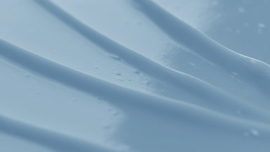 Blue body care cream furrow texture with a reflection of light