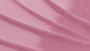 Pink body care cream furrow texture with a reflection of light