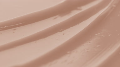 Beige lifting cream furrow texture with a reflection of light