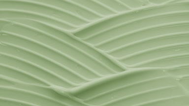 Macro shot of green day cream with linseed oil wave texture