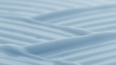 Macro crane shot of blue moisturizing cream wave texture