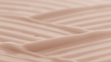 Macro crane shot of beige moisturizing cream wave texture