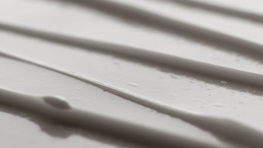 Macro turntable shot of white anti-aging cream furrow texture