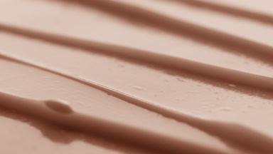 Macro turntable shot of beige anti-aging cream furrow texture