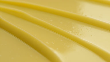 Yellow anti-wrinkle cream texture with a reflection of light