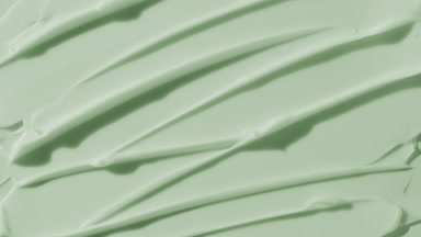 Green anti-aging cream furrow texture appears from the shadow