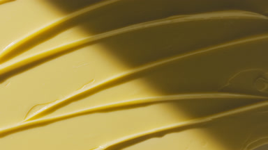 Yellow anti-acne cream furrow texture appears from the shadow