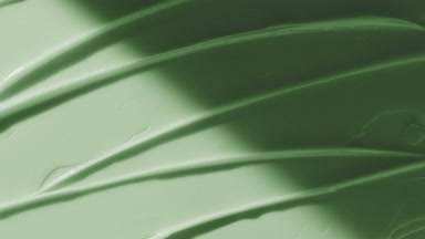 Green anti-acne cream furrow texture appears from the shadow