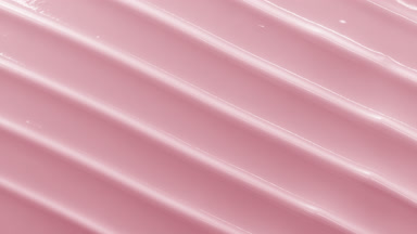 Top view macro turntable shot of pink cosmetic cream