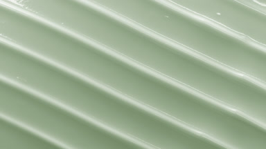 Top view macro turntable shot of pale green cosmetic cream