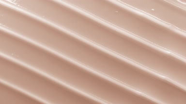 Top view macro turntable shot of beige cosmetic cream