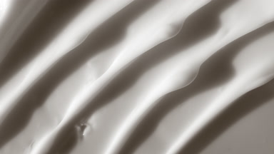 Macro shot of white night cream with moving light source