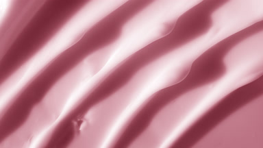 Macro shot of pink night cream with moving light source