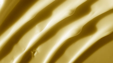 Macro shot of yellow night cream with moving light source