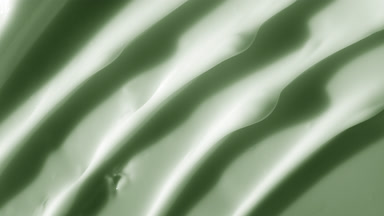 Macro shot of white green cream with moving light source