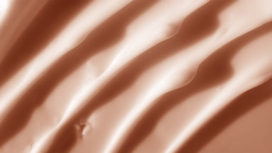 Macro shot of white beige cream with moving light source
