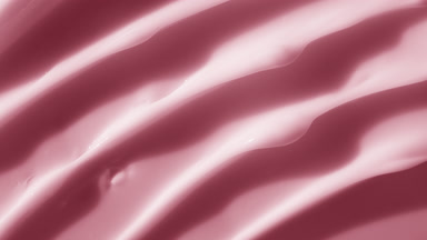Top view macro texture of pink anti-aging cream with rose oil