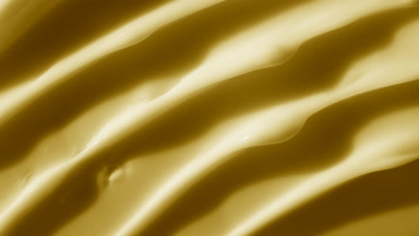 Top view macro texture of yellow chamomile face cream