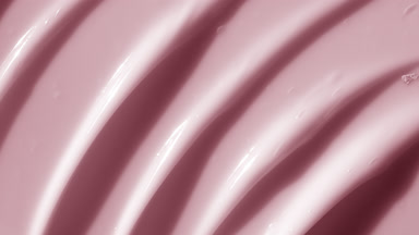 Top view macro texture of pink anti-aging cream with retinol